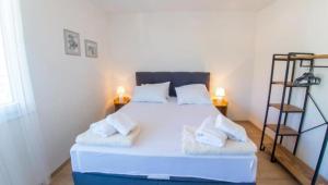 a bedroom with a large white bed with white pillows at Francis First in Mostar