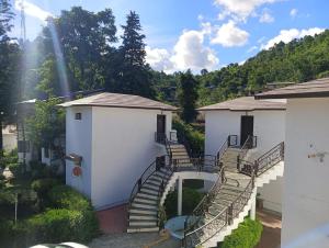 a building with stairs and a stair case in front at Shikha Resort Ewentbliz in Bhīm Tāl