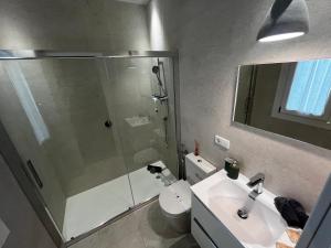 a bathroom with a shower and a toilet and a sink at Kadis-Korazon Grupo AC Gestion in Cádiz