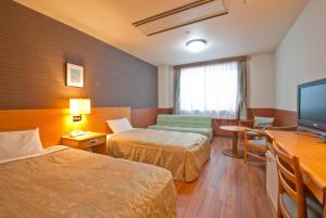 Postel nebo postele na pokoji v ubytování Hotel Familio Minakami