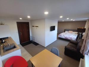 a room with a bed and a couch and a table at Ubytovanie Pod lesom in Ľubica