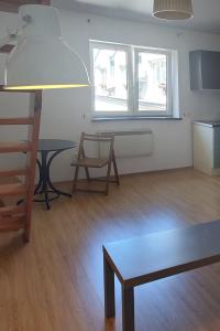 a living room with a table and a bench and two windows at Take a rest in the center of Krakow, Zyblikiewicza in Kraków