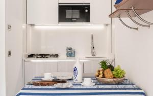 a kitchen with a table with a basket of fruit at Costa Rica Bibione Eco Resort in Bibione