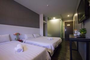 Postel nebo postele na pokoji v ubytování Chariton Hotel Ipoh