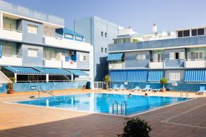 a swimming pool in front of a building at Home2Book Bright Apt in Puertito, Terrace & Pool in Puertito de Güímar