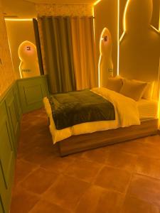 a bedroom with a bed with two faces on it at Vintage Green House in Fez