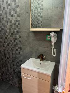 a bathroom with a sink and a mirror at Vintage Green House in Fez