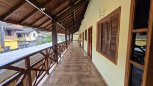 a corridor of a house with a balcony at Apto Girassol in Monte Verde