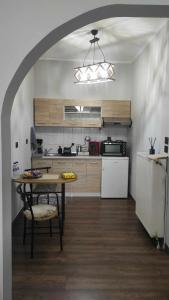 a kitchen with a table and chairs and a table and a kitchen at Casablanca Orestiada in Orestiada +8 photos