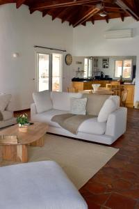 a living room with a white couch and a table at Villa Camélia in Oyster Pond +21 photos