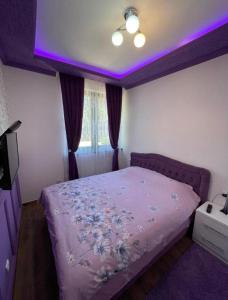 a bedroom with a bed with a purple ceiling at VIOLET QUEEN in Kopaonik +31 photos