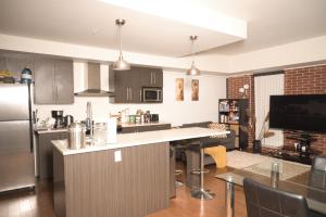 a kitchen with a refrigerator and a counter top at Minimum one month - Room with Ensuite Bathroom in fairly new 2 rooms, 2 bathrooms condo in Ottawa