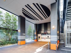 a hallway with a kitchen in a building at APA Hotel & Resort Osaka Namba Ekimae Tower in Osaka