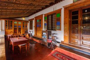 a room with a table and chairs and a room withwindows at Sea Hut Homestay in Cochin