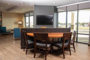 a conference room with a table and chairs and a flat screen tv at TownePlace Suites by Marriott Petawawa in Petawawa