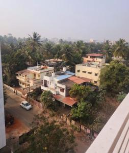 an aerial view of a city with houses and a car at Whispering Wind Homestay in Kolhapur +16 photos