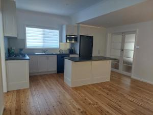 a kitchen with white cabinets and a black counter top at Dally's Nashdale in Nashdale