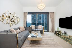 a living room with a couch and a tv at NewArabian Act Two T2 2 BR and 3 BR in Dubai
