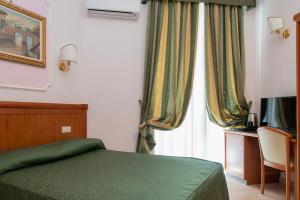 Postel nebo postele na pokoji v ubytování Hotel Philia