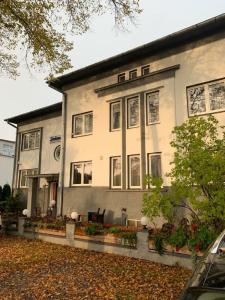 a large white building with windows and plants at Sadama kvartal in Pärnu