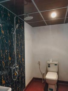 a bathroom with a shower and a toilet in a room at Lodgepole Pine Resorts in Welimada +25 photos