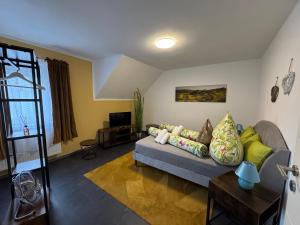 a living room with a couch and a tv at Ada&Cris Apartament in Klotten