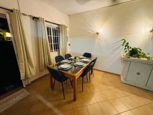 a dining room with a table and chairs and a television at Cosy duplex in Res les Barachois 3,Grand-Gaube in Grand Gaube