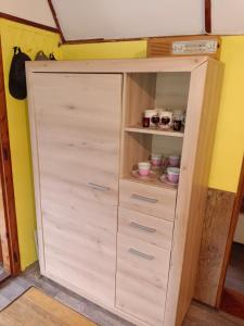 a large wooden cabinet in a room at Chata Evička a Jiříček in Raškovice