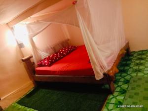 a red bed with a canopy in a room at Koh Phu Valley in Ko Jum +58 photos