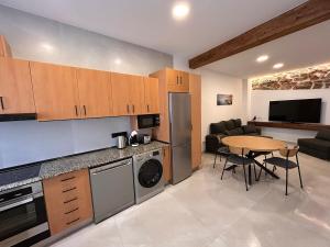 a kitchen with a table and a dining room at Apartamento La Fragua - A ESTRENAR - BRAND NEW in Chulilla