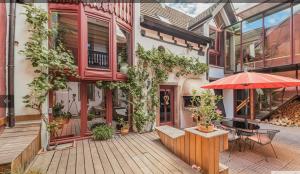 an outdoor patio with a table and an umbrella at Colmar guesthouse in old town 6 people in Colmar