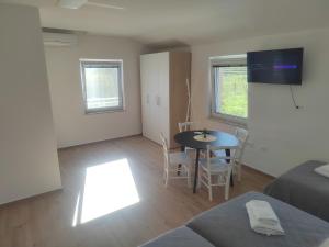 a living room with a table and a couch at Studio Apartma KIMI in Nova Gorica