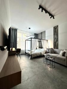 a living room with a couch and a bed at Dubois Apartment - Self Check-In 20h in Wrocław