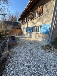 a house with a bench in front of a building at Charmante maison à Saint Béron in Saint-Béron