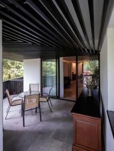 a living room with a table and chairs on a patio at Poiana Brasov Alpin Resort Apartment in Poiana Brasov