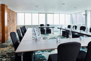 a conference room with long tables and chairs at Manchester Marriott Victoria & Albert Hotel in Manchester