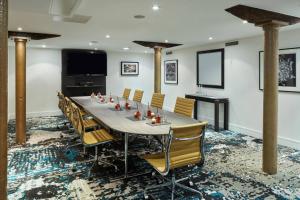 a conference room with a long table and chairs at Manchester Marriott Victoria & Albert Hotel in Manchester