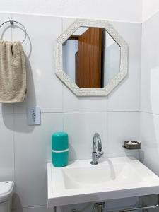 a bathroom with a sink and a mirror at Chales Estiva Nova in Mucugê +63 photos