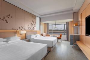 Ein Bett oder Betten in einem Zimmer der Unterkunft Surat Marriott Hotel