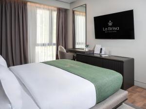 a hotel room with a bed and a desk at La Brisa Boutique Hotel in Dhërmi