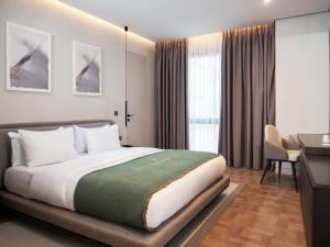 a bedroom with a bed and a desk in a room at La Brisa Boutique Hotel in Dhërmi