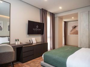 a hotel room with a bed and a desk at La Brisa Boutique Hotel in Dhërmi