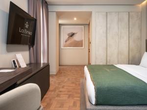 a hotel room with a bed and a desk at La Brisa Boutique Hotel in Dhërmi