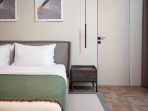 a bedroom with a bed next to a door at La Brisa Boutique Hotel in Dhërmi