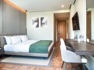 a hotel room with a bed and a desk at La Brisa Boutique Hotel in Dhërmi