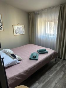 a bedroom with a bed with two towels on it at Marvellous 2 Bedrooms Attic in the Old Town in Bucharest