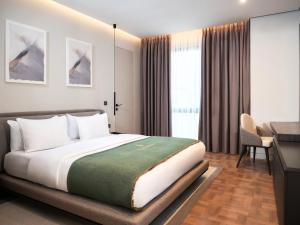a hotel room with a bed and a desk and a desk at La Brisa Boutique Hotel in Dhërmi