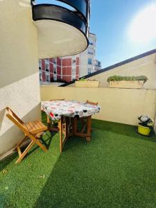 a table and a chair on a balcony at Charmant appartement en plein centre ville de Nogent sur Marne in Nogent-sur-Marne
