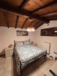 a bedroom with a bed in a room with wooden ceilings at Aryhouse in Terni