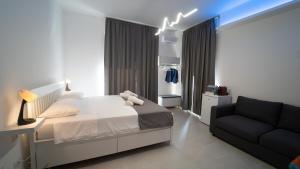 a bedroom with a bed and a couch at Cleli in Giardini Naxos